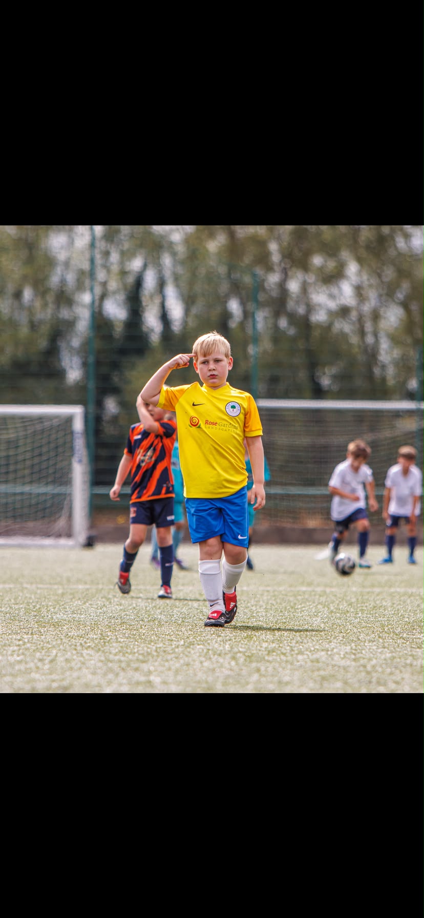 Young Woolton Villa football player wearing a Rose Gardens sponsored kit