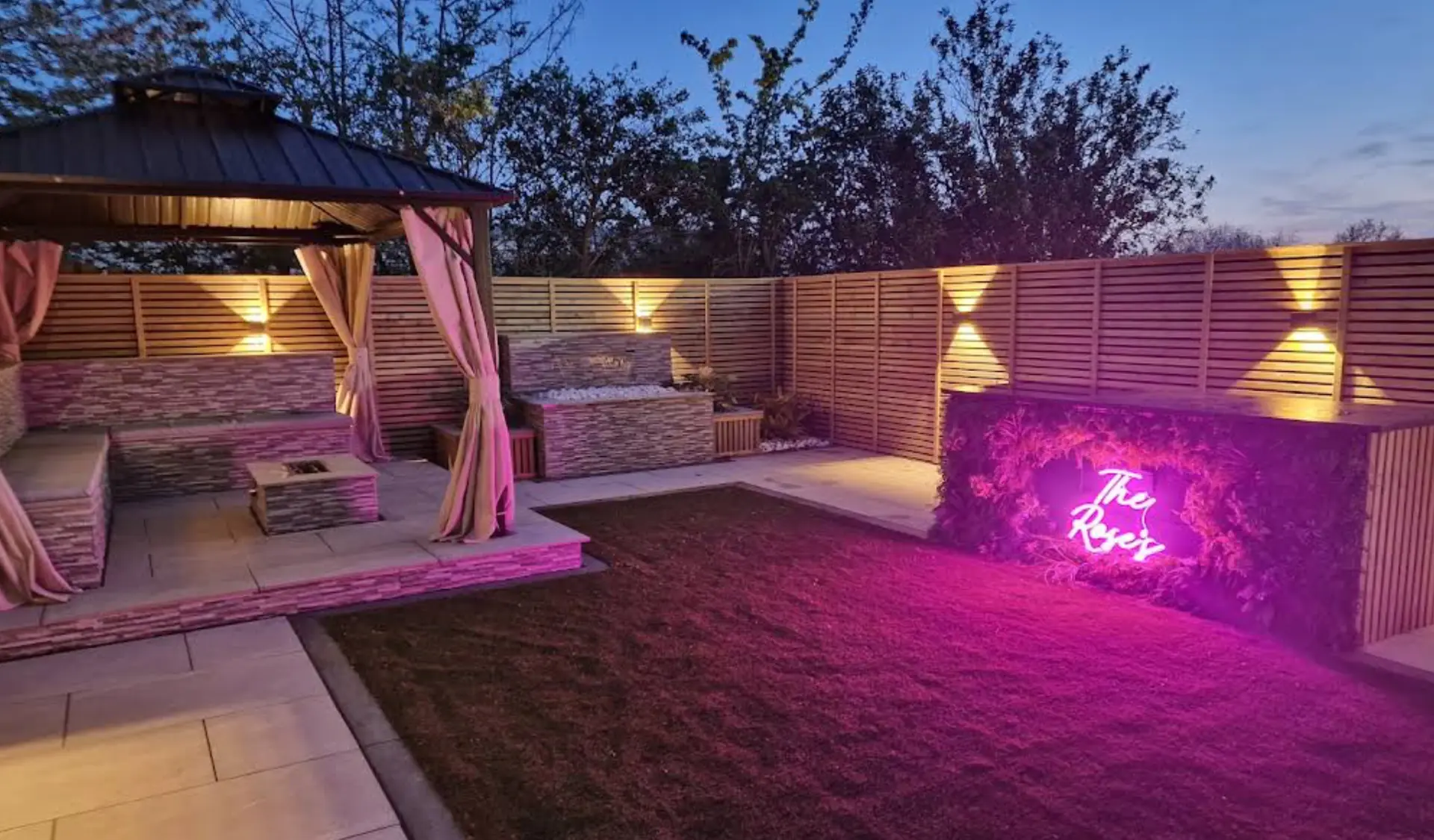 Complete garden transformation with illuminated gazebo, paving and built-in seating