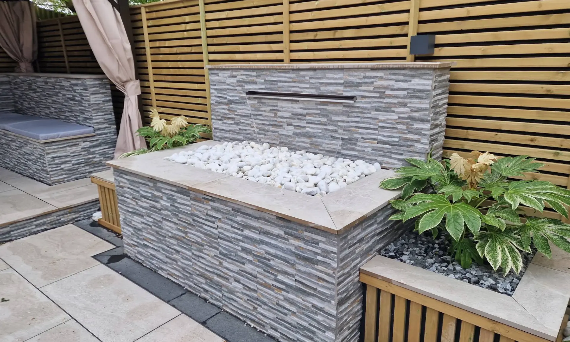 Stone water feature, planting and timber fencing detail